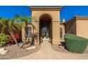 Inviting front entrance with arched entryway and landscaping at 12159 N 120Th Way, Scottsdale, AZ 85259