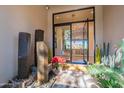 Beautiful foyer featuring unique water feature, plants, and glass front door at 13412 N 14Th Pl, Phoenix, AZ 85022