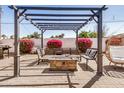Relaxing backyard patio area with a stylish pergola, perfect for outdoor entertaining and leisure at 1815 N 74Th St, Scottsdale, AZ 85257