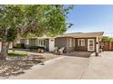 Inviting front exterior showcasing a well-lit entrance, complemented by a spacious driveway at 1815 N 74Th St, Scottsdale, AZ 85257