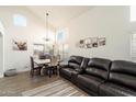 Spacious living room featuring a leather sectional sofa and a rustic dining table at 1836 N Stapley Dr # 78, Mesa, AZ 85203