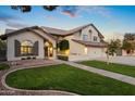 Two-story house with a landscaped yard, double garage, and walkway at 1848 E Mallory St, Mesa, AZ 85203