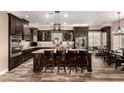 Spacious kitchen with island, dark wood cabinets, and stainless steel appliances at 22951 W La Mirada Dr, Buckeye, AZ 85326