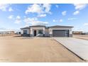 Single-story home with gray garage door and stone accents at 28813 N 201St Ave, Wittmann, AZ 85361