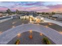 Stunning aerial view of a modern home with a circular driveway and beautifully landscaped yard at 2911 W Latona Rd # 1, Laveen, AZ 85339