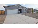Beautiful home featuring a spacious driveway and low-maintenance desert landscaping at 46941 W Old Timer Rd, Maricopa, AZ 85139