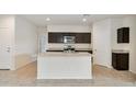 Kitchen island with granite countertop and dark cabinetry at 641 W Freedom St, Florence, AZ 85132