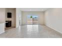 Spacious living room with tile flooring and sliding glass doors to backyard at 641 W Freedom St, Florence, AZ 85132