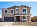 Charming two-story home showcasing a well-manicured front yard and an attached two-car garage at 7662 W Rowel Rd, Peoria, AZ 85383