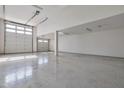 Spacious two-car garage with high ceilings and epoxy flooring at 8026 W Wood Ln, Phoenix, AZ 85043