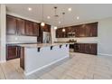 Modern kitchen featuring granite countertops and dark wood cabinetry at 8026 W Wood Ln, Phoenix, AZ 85043
