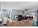 Spacious living room with L-shaped sectional sofa and tile floors at 11227 W Phillip Jacob Dr, Surprise, AZ 85378