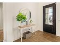 Bright entryway with a white console table, round mirror, and wood floors at 12058 N Loma Linda St, Surprise, AZ 85388