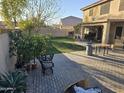 Large backyard with patio, grass, and fruit trees at 12701 W Paradise Dr, El Mirage, AZ 85335