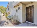 Front entrance with wrought iron door and well-manicured plants at 12851 N Mimosa Dr # 102, Fountain Hills, AZ 85268