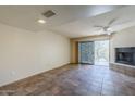 Living room with tile floors, fireplace, and sliding glass doors leading to a patio at 12851 N Mimosa Dr # 102, Fountain Hills, AZ 85268