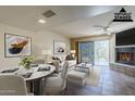 Virtually staged living room with dining area and fireplace at 12851 N Mimosa Dr # 102, Fountain Hills, AZ 85268