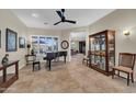 Spacious living area featuring tile flooring, natural light, piano, and comfortable seating at 12953 W Figueroa Dr, Sun City West, AZ 85375
