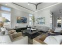 Spacious living room with modern furniture and a large TV at 14821 E Chandler Heights Rd, Chandler, AZ 85249