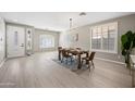 Bright dining room with hardwood floors and a modern chandelier at 14866 W Windsor Ave, Goodyear, AZ 85395