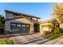 Two-story house with a green door, landscaping, and a large driveway at 15244 W Alexandria Way, Surprise, AZ 85379