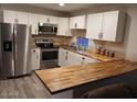 Spacious kitchen with butcher block countertops and stainless steel appliances at 156 N Hawes Rd # 75, Mesa, AZ 85207