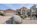 Tan house with a two-car garage and desert landscaping at 17421 E Via Del Oro --, Fountain Hills, AZ 85268
