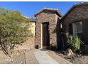 Stone entryway with an iron gate leading to the front door at 17531 W Liberty Ln, Goodyear, AZ 85338