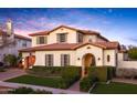 Two-story house with arched entryway and well-maintained landscaping at 20606 W Daniel Pl, Buckeye, AZ 85396