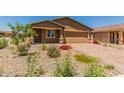 New single-story house with a two-car garage, and well-maintained landscaping at 25838 W Samantha Way, Buckeye, AZ 85326