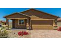 Charming new construction home with a two-car garage and nicely landscaped yard at 25838 W Samantha Way, Buckeye, AZ 85326