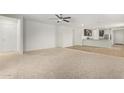 Spacious living room with carpeted floors and open floor plan at 25838 W Samantha Way, Buckeye, AZ 85326