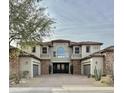 Two-story home with stone accents and three-car garage at 3957 E Expedition Way, Phoenix, AZ 85050