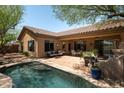 Relaxing backyard oasis with a refreshing pool and spacious patio at 41007 N Harbour Town Way, Anthem, AZ 85086