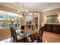 Elegant dining room featuring a large table and hardwood floors at 41007 N Harbour Town Way, Anthem, AZ 85086