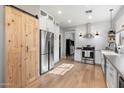 Modern kitchen with stainless steel appliances and a farmhouse sink at 42949 N Voyage Trl, Phoenix, AZ 85086