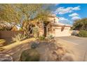 Two-story house with desert landscaping and a three-car garage at 4516 E Madre Del Oro Dr, Cave Creek, AZ 85331