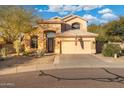 Two-story house with desert landscaping and a three-car garage at 4516 E Madre Del Oro Dr, Cave Creek, AZ 85331