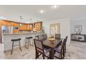 Kitchen with granite countertops and wooden cabinetry, adjacent to dining area at 5320 N 79Th Way, Scottsdale, AZ 85250