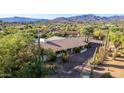 Single story home with mountain views and a long private driveway at 7760 E Carefree Dr, Carefree, AZ 85377