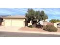 Charming single-Gathering home with a three-car garage, desert landscaping, and a well-kept front yard at 8014 E Plata Ave, Mesa, AZ 85212