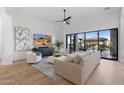 Bright living room with large windows, stylish seating, and a modern aesthetic at 8040 E Laurel St, Mesa, AZ 85207