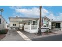 Mobile home with covered carport and desert landscaping at 880 Motherlode Dr # 1099, Apache Junction, AZ 85119
