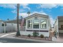 Mobile home with covered carport and desert landscaping at 880 Motherlode Dr # 1099, Apache Junction, AZ 85119