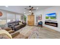 Relaxing living room featuring a fireplace, leather furniture, and a large TV at 11596 W Sierra Dawn -- # 132, Surprise, AZ 85378