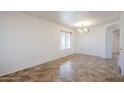 Bright dining room with tiled floors and a chandelier at 16649 W Polk St, Goodyear, AZ 85338