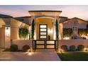 Elegant entryway with modern glass door and landscaping at 1710 W Glacier Way, Chandler, AZ 85248