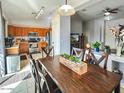 View of the dining area and kitchen featuring a dining table and stainless steel appliances at 17545 W Canyon Ln, Goodyear, AZ 85338