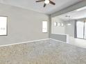 Bright living room with neutral tones, carpet flooring, and seamless flow to dining area at 17545 W Canyon Ln, Goodyear, AZ 85338