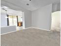 Open concept living room with carpeted floors and easy access to kitchen and backyard at 17545 W Canyon Ln, Goodyear, AZ 85338